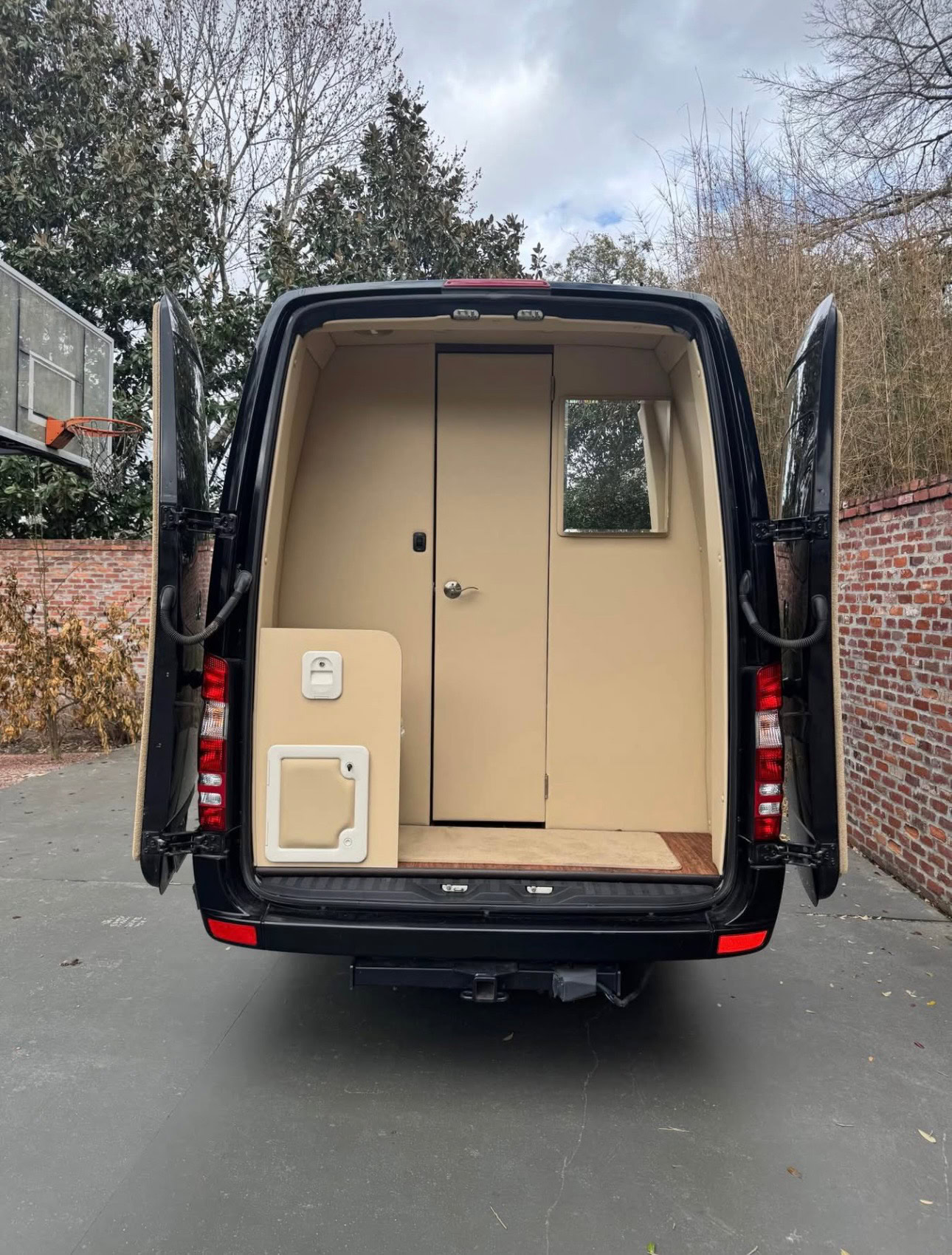 Interior view of a luxury van used for limousine rentals, showcasing spacious and comfortable seating with modern amenities for a premium transportation experience.