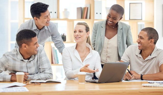 Diverse property management team collaborating in an office, discussing strategies for selecting the best property management company.