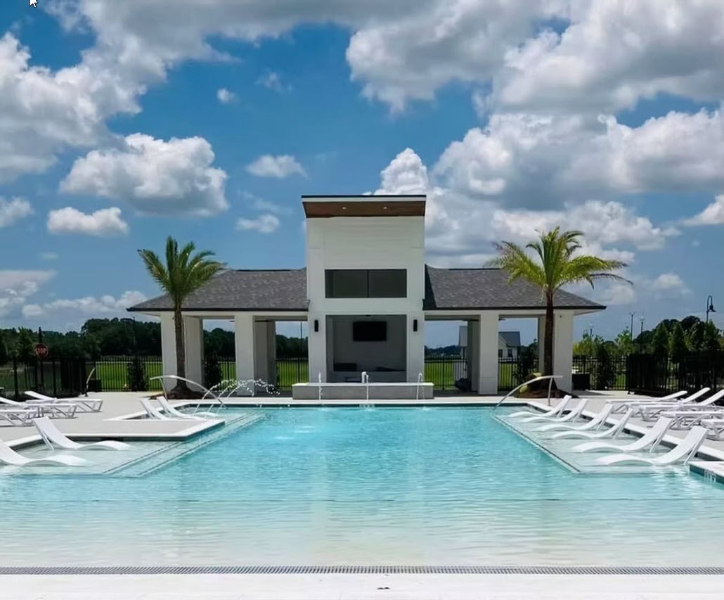 Elegant outdoor swimming pool with a contemporary pavilion, surrounded by palm trees and lounge chairs, ideal for relaxation and leisure in a serene environment.